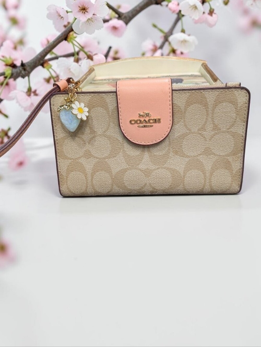 COACH Beige Signature Canvas Wristlet with Pink Trim and Charm